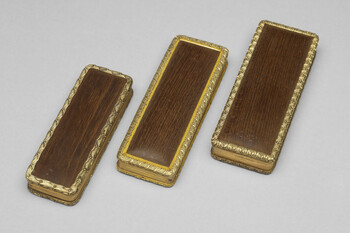 Three gold-trimmed rectangular boxes, each open at the hinge to display a mirrored lining. Two of them have inscriptions reading 'Made of the Mulberry Tree planted by Shakespeare'. The central box has the inscription "This Wood was part of the Mulberry Tree planted by Shakespeare."